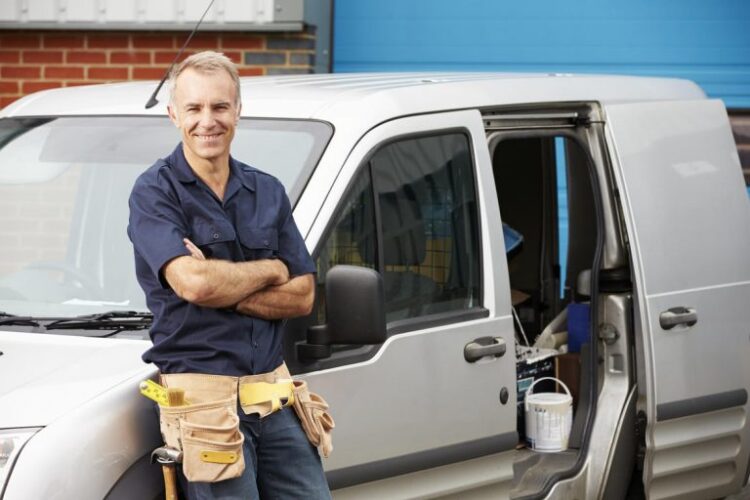 Contractor with Commercial Auto Insurance, Smiling While Standing By Their Car in Peabody, MA